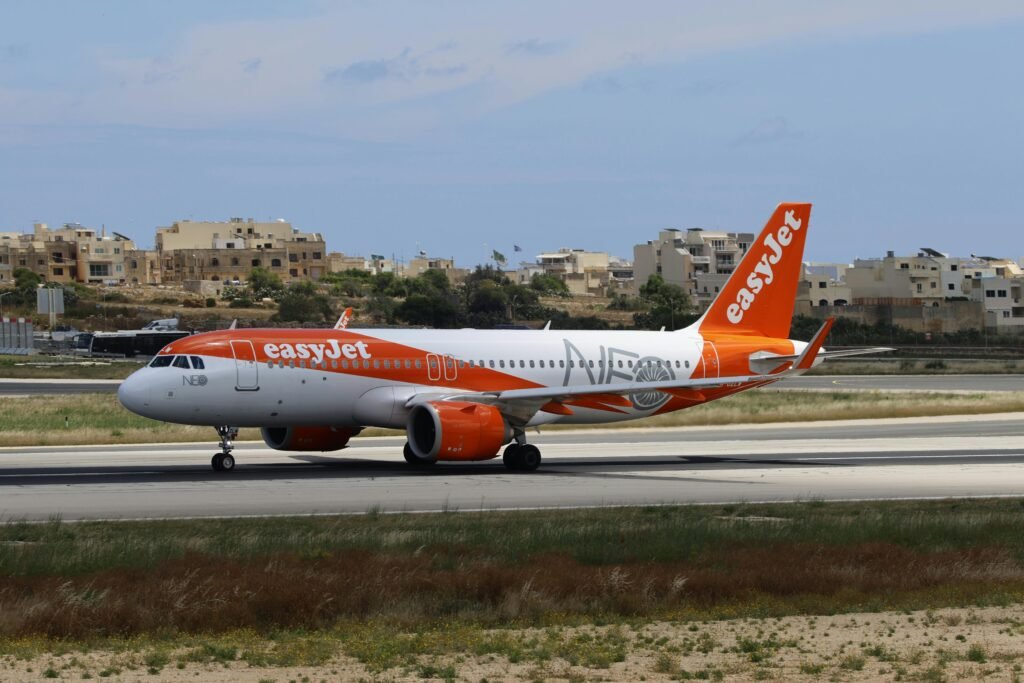 An easyjet airplane preparing for takeoff on a sunny day at the airport.
